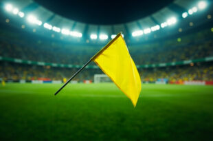 Yellow penalty flag thrown on football field at Arena Corinthians stadium in Brazil
