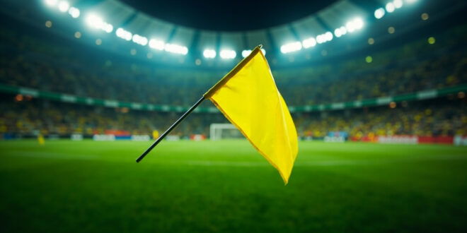 Yellow penalty flag thrown on football field at Arena Corinthians stadium in Brazil