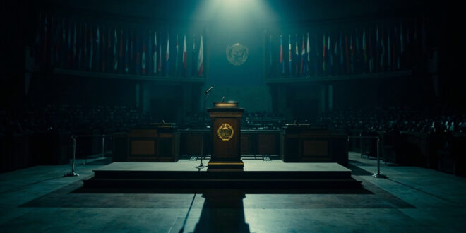Empty UN General Assembly podium with microphone and scattered diplomatic flags in darkened chamber