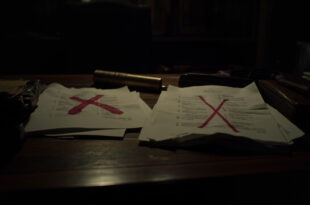 Government budget folders with red stamps and crossed-out figures scattered on wooden desk with filing cabinets