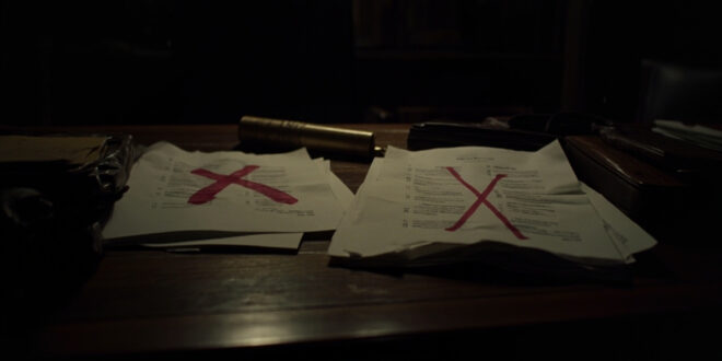 Government budget documents with red markings and calculator on official desk showing foreign aid funding cuts