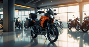 Orange and black adventure motorcycle with side cases in motorcycle showroom under bright lighting