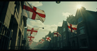Red and white St George Cross flags flying from lampposts on residential street with council building backdrop