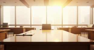 Empty corporate office with wooden desk, papers, and morning sunlight streaming through windows