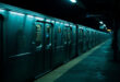 Empty subway train at dark station platform, closed doors, overhead lights casting long shadows on concrete