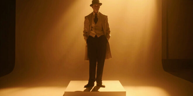 Vintage menswear suit with vest, tie and wide-brimmed hat displayed on stand against dark theatrical backdrop