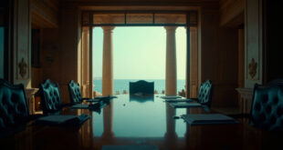 Empty conference room with negotiation table, documents, and Red Sea view through large windows