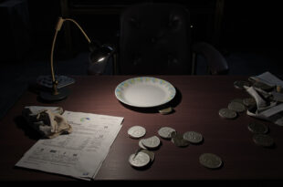 Coins and tax documents on dark desk with empty chair representing restaurant tax dispute