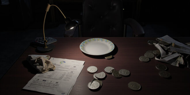 Coins and tax documents on dark desk with empty chair representing restaurant tax dispute