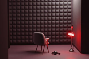 Empty podcast studio with vintage microphone, headphones on chair, and glowing red recording light