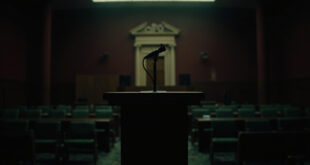 Empty wooden podium with microphone in formal government press room with burgundy and green institutional colors