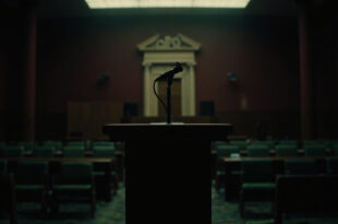 Empty wooden podium with microphone in formal government press room with burgundy and green institutional colors