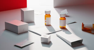 Medication bottles and sealed envelopes arranged on white medical surface with legal papers