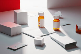 Medication bottles and sealed envelopes arranged on white medical surface with legal papers