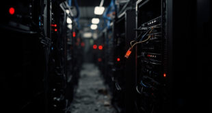 Unplugged ethernet cable hanging from dark server rack with scattered red warning indicator lights in data center