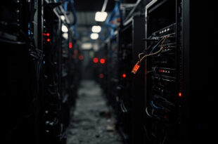 Unplugged ethernet cable hanging from dark server rack with scattered red warning indicator lights in data center