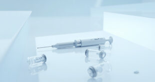 GLP-1 injection pen and medication vials arranged on white clinical surface with soft lighting