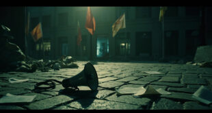 Silent megaphone on cobblestone plaza with scattered papers and empty demonstration area