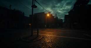 Empty urban crossroads with streetlamp glowing at dusk, cobblestone pavement and long shadows stretching across intersection