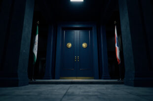 Closed ornate doors in government building hallway with flags and official architectural details
