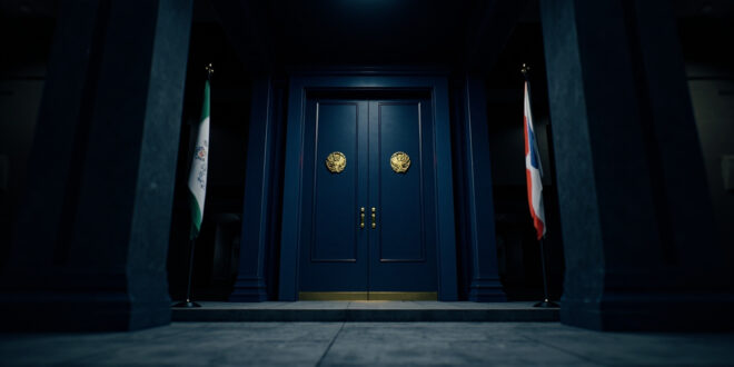 Closed ornate doors in government building hallway with flags and official architectural details