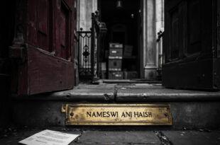 Brass nameplate and envelope on stone steps of grand estate entrance with iron gates ajar under overcast sky