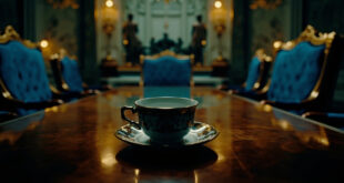 Empty ornate chairs and formal tea service in palace room with royal blue and gold decor