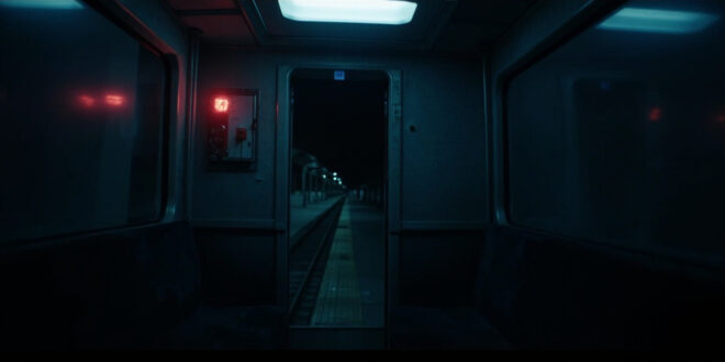 Empty train carriage interior with illuminated emergency button and fluorescent lighting casting stark shadows