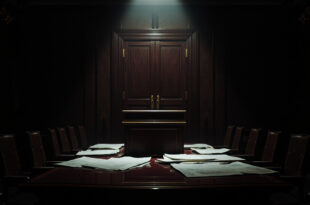 Empty government briefing room with podium, scattered papers, and closed doors in moody lighting.