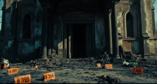 Burned church building exterior with charred walls and emergency investigation equipment scattered around the entrance