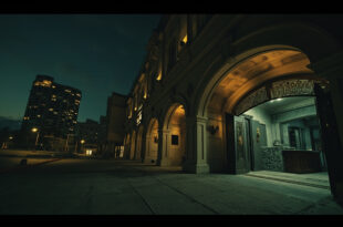 Exterior view of closed luxury hotel building in Cairo with darkened windows and empty entrance area at twilight