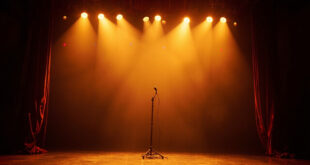 Empty concert stage with red velvet curtains opening, golden spotlights creating dramatic beams through darkness
