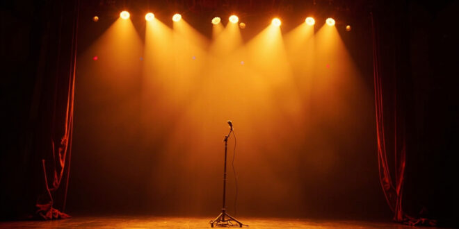 Empty concert stage with red velvet curtains opening, golden spotlights creating dramatic beams through darkness