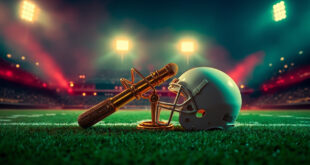 Microphone and football helmet side by side on stadium field under dramatic lighting