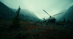 Helicopter wreckage on rocky Montana mountainside with distant peaks under gray sky