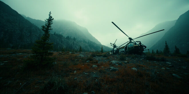 Helicopter wreckage in remote Montana mountain terrain under overcast sky