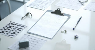 Medical cognitive test forms with animal icons and geometric patterns on clinical examination table under overhead light