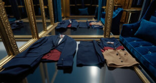 Formal navy dress and casual clothing displayed side by side in an elegant room with mirrors and soft lighting